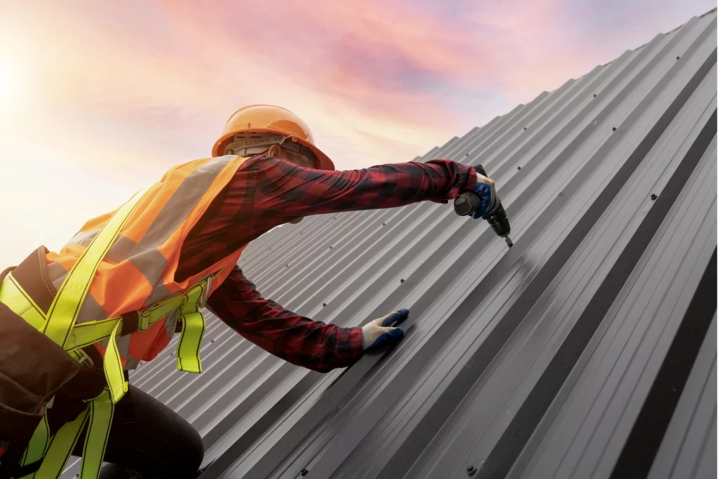 man fixing metal roof